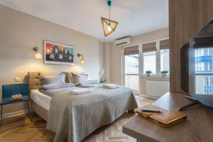 Postel nebo postele na pokoji v ubytování P&O City Center Apartments