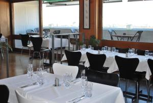 a dining room with white tables and chairs at Hotel le Corbusier in Marseille