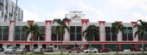 a large building with cars parked in front of it at HL HOTEL Kota Bharu in Kota Bharu