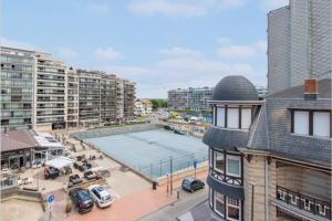 an aerial view of a city with a tennis court at Casa Quatre-Mains Westende in Westende