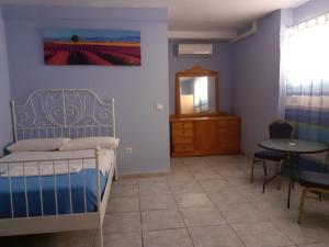 a bedroom with a bed and a table and a mirror at Tenerife Hostel in Los Cristianos