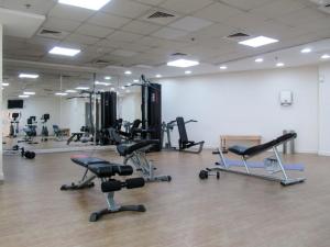 a gym with several exercise equipment in a room at Frank Porter - Burj Al Nujoom in Dubai