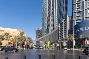 a parking lot in a city with tall buildings at Frank Porter - Burj Al Nujoom in Dubai