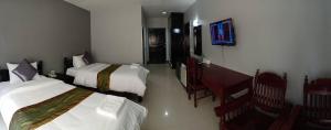 Postel nebo postele na pokoji v ubytování Submukda Phoomplace Hotel