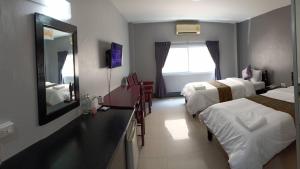 Postel nebo postele na pokoji v ubytování Submukda Phoomplace Hotel