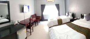 Postel nebo postele na pokoji v ubytování Submukda Phoomplace Hotel