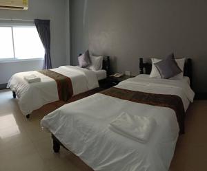 Postel nebo postele na pokoji v ubytování Submukda Phoomplace Hotel