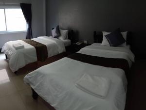 Postel nebo postele na pokoji v ubytování Submukda Phoomplace Hotel
