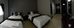 Postel nebo postele na pokoji v ubytování Submukda Phoomplace Hotel