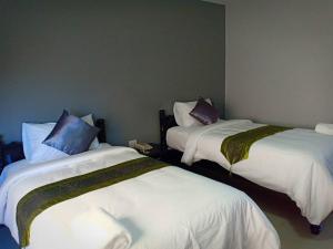 Postel nebo postele na pokoji v ubytování Submukda Phoomplace Hotel