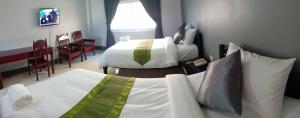 Postel nebo postele na pokoji v ubytování Submukda Phoomplace Hotel