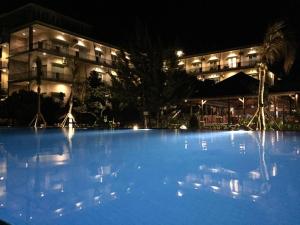 a large pool of blue water in front of a building at Padadita Beach Hotel in Waingapu