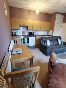 a living room with a couch and a table at Gwynedd House Flat 2 in Pentraeth