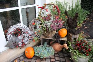 a bunch of pumpkins and a vase of flowers on a porch at Gästehaus Niemerg in Warendorf