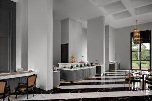 a lobby with chairs and a bar in a building at Sirinati Ban Thung Samo Khao Kho in Khao Kho
