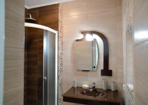 a bathroom with a sink and a mirror at Centrum Apartment Senta in Senta