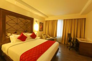 A bed or beds in a room at The Saibaba Hotel