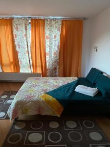 a bed in a bedroom with orange curtains at Villa Predeal in Predeal