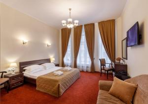a hotel room with a bed and a couch at Sonata Nevsky 5 Palace Square in Saint Petersburg