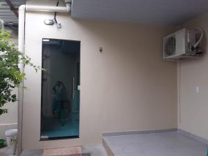 a building with a door with a window and a fan at Edward Suíte Manaus 03 in Manaus