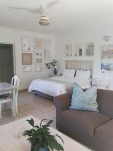 a living room with a bed and a couch at Claire's Deluxe Studio Apartment - SOLAR in Ballito