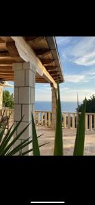 a building with a view of the ocean in the background at Casa Fortuna in Sveta Nedelja