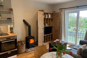 a living room with a fireplace and a stove at The Lambing Shed in Bushmills