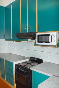 a kitchen with a stove and a microwave at Frere Hill in Durban