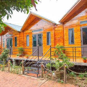 a wooden house with a staircase in front of it at Homestay 368 in Chung Cap