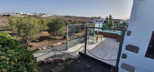 une maison avec un balcon en verre et une terrasse dans l'établissement Caserío Leandro IV, à Tías