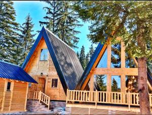 a log cabin with a blue roof at ZLATARSKA IDILA in Nova Varoš