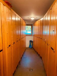 a row of wooden lockers in a locker room at Parenthèse à la montagne in Bessans +3 photos
