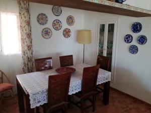 a dining room with a table and plates on the wall at Casa Pilar in Perelló