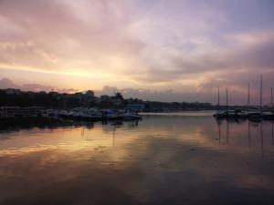 a marina with boats in the water at sunset at Apartament Lara in Constanţa
