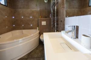 a bathroom with a tub and a toilet and a sink at ღ Joli appartement T2 40m2 ღ in Magny-le-Hongre