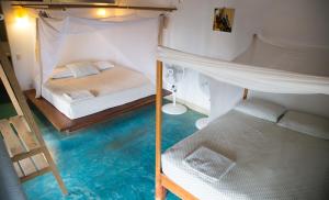 Una cama o camas en una habitación de Un Sueño Cabañas del Pacífico