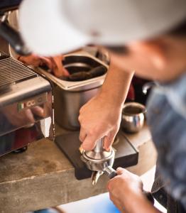 a man is using a mixer in a kitchen at Un Sueño Cabañas del Pacífico in San Agustinillo