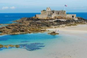 a castle on an island in the ocean at Le Plongeoir de Bon-Secours in Saint Malo +3 photos