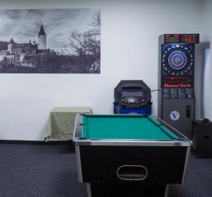 a pool table in a room next to a wall at Hotel Sýkora in Křivoklát