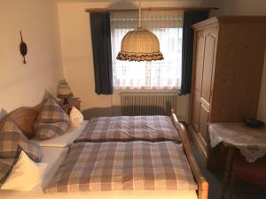 a bedroom with a bed in front of a window at Ferienwohnung Weißenbacher in Grassau