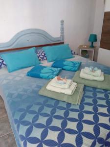 Pino's Vivienda Vacacional في طوستا ديل سيلونثيو: غرفة نوم بسريرين عليها مناشف