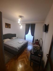 a bedroom with a bed and a television in it at Republicii Apartment in Braşov