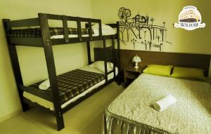 a bedroom with two bunk beds and a bed at Waldorf in Lima
