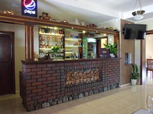 a bar in a restaurant with a brick wall at Noclegi Sobańskich in Gniezno