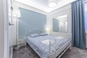 a bedroom with a bed and a large mirror at Boleslav Home De Luxe in Sucha Beskidzka
