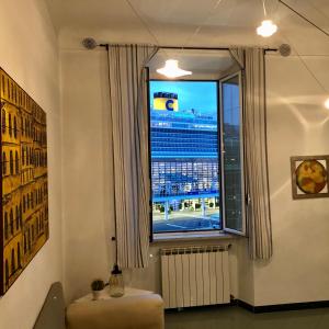 a room with a window with a view of a building at Relax in Darsena - Savona in Savona