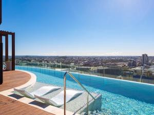 a swimming pool with a view of a city at FV By Serain Residences in Brisbane