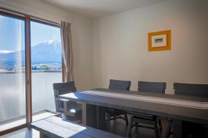 a conference room with a table and chairs and a mountain at Villas Asama no Iori in Fujiyoshida