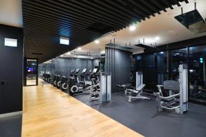 a gym with a lot of treadmills and machines at FV By Serain Residences in Brisbane