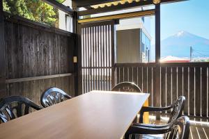 a table and chairs with a view of a mountain at Villas Asama no Iori in Fujiyoshida